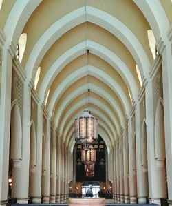 Chandeliers hanging from arch ceiling in corridor