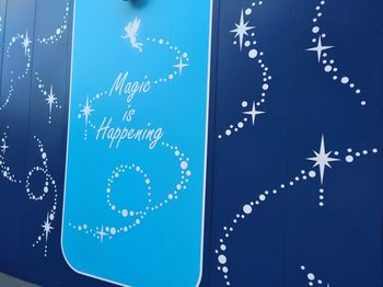 Low angle view of text against blue background