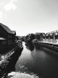 River by houses against sky