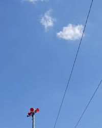 Low angle view of cables against blue sky