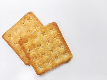 High angle view of bread in plate against white background