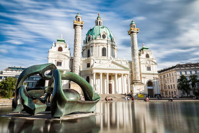 View of sculpture of building against cloudy sky