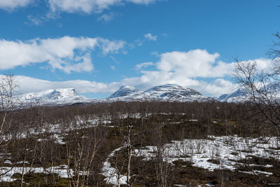 Scenic view of snowcapped mountains against sky