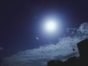 Low angle view of moon over sea against sky