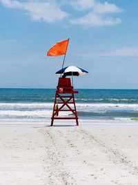 Lifeguard hut on beach against sky