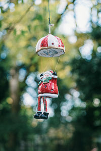 Close-up of red toy hanging on tree