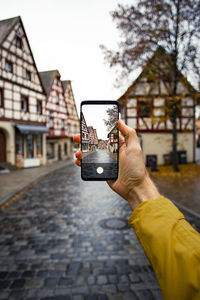 Man photographing with mobile phone in building