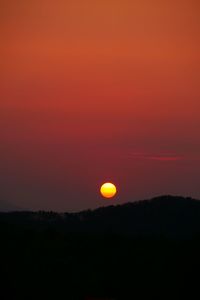 Silhouette landscape against romantic sky at sunset