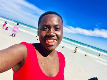 Portrait of smiling young woman on beach