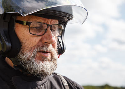 Close-up of senior man wearing helmet