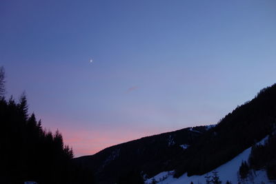 Scenic view of silhouette mountains against sky at night