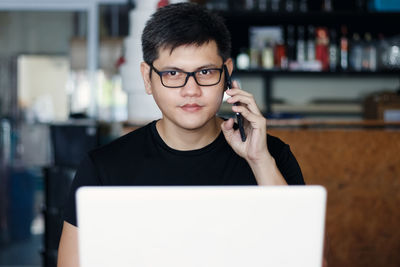 Portrait of mature man using smart phone