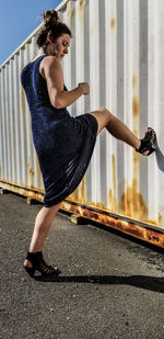 Woman kicking cargo container