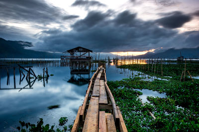 Pier over lake against sky