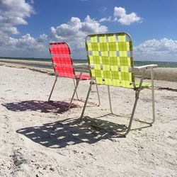 Lounge chairs on beach against sky