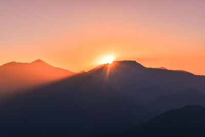 Scenic view of silhouette mountains against sky during sunset