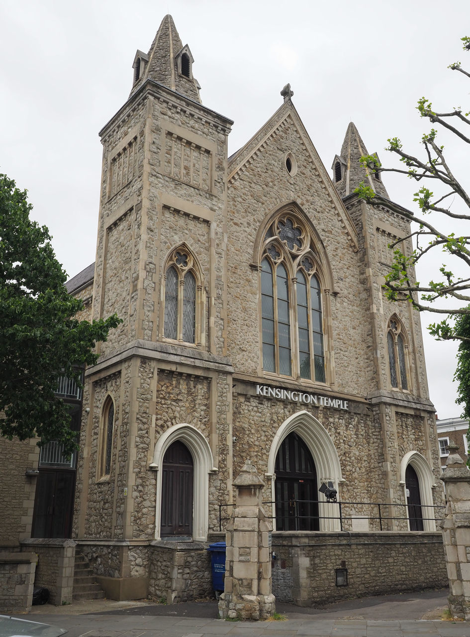 architecture, building exterior, built structure, religion, place of worship, building, belief, history, the past, spirituality, arch, travel destinations, nature, sky, city, facade, catholicism, tree, day, tourism, travel, entrance, plant, outdoors, tower, no people