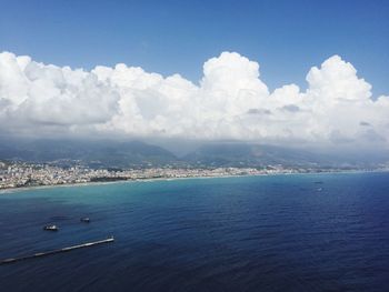 Aerial view of sea against cumulus clouds