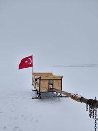 Lifeguard hut on snow field against clear sky