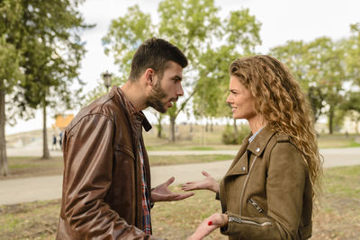 Couple arguing against trees