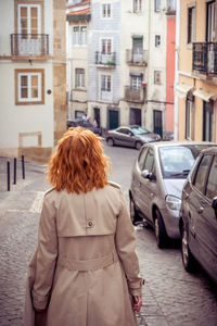 Rear view of woman walking on street in city