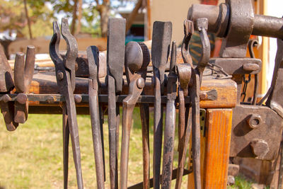 Close-up of rusty metallic hand tools hanging outdoors