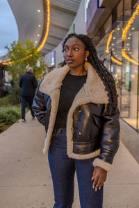 Side view of young woman standing at airport