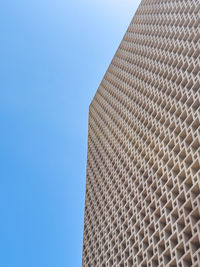 Low angle view of skyscraper against clear blue sky