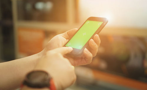 Close-up of hand holding mobile phone