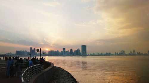 City at waterfront during sunset