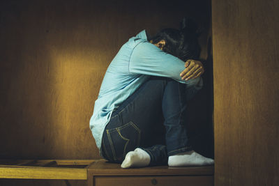 Depressed woman sitting at home