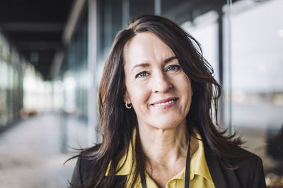 Portrait of female entrepreneur standing at workplace