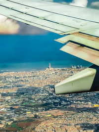 Aerial view of sea and buildings against sky