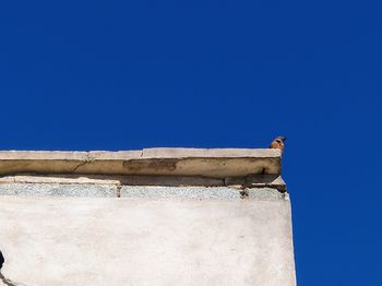 Low angle view of building against clear blue sky