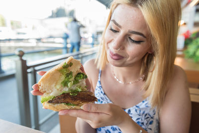 Young woman holding ice cream