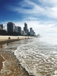 Sea and buildings against sky