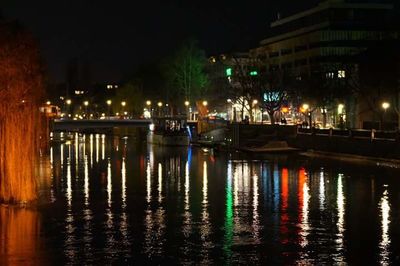 Reflection of illuminated buildings in water at night