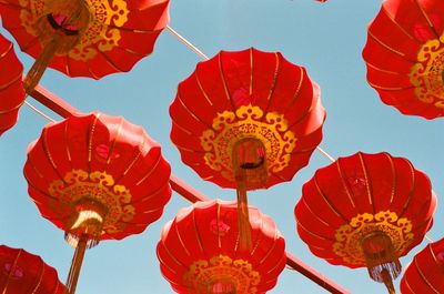 Low angle view of lanterns hanging against sky