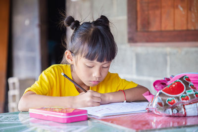 Portrait of girl looking at table