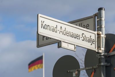 Low angle view of road sign against sky