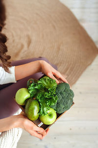 High angle view of woman holding fruit