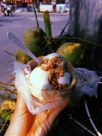 Close-up of hand holding ice cream