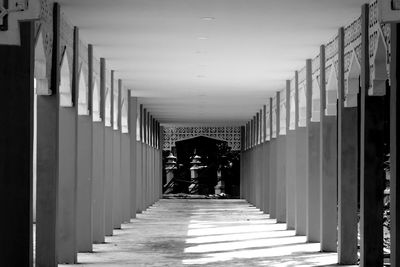 Rear view of people walking on corridor of building