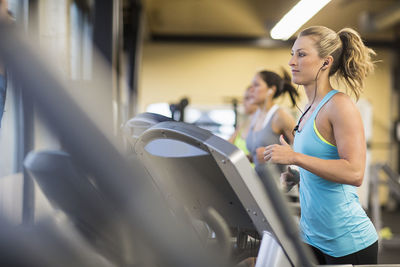 Women exercising on treadmills in gym