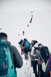 People skiing on mountain during winter