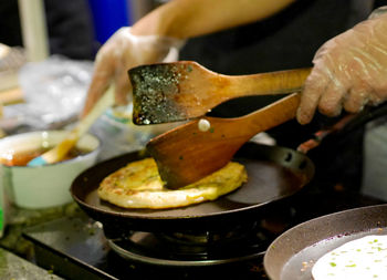 Cropped hand preparing food