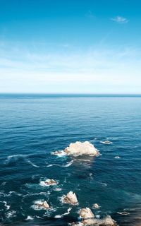 Scenic view of sea against blue sky