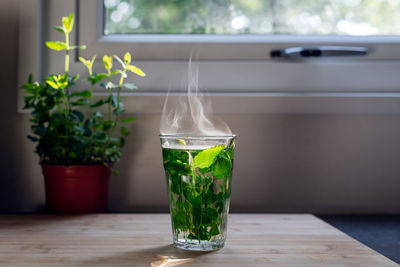 A glass of freshly brewed mint tea is on the table.