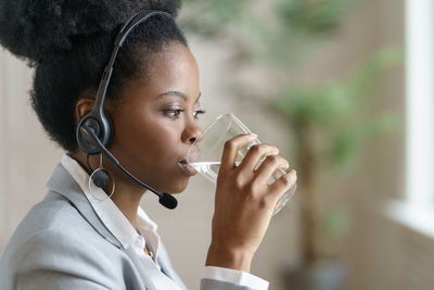 Close-up of businesswoman drinking water