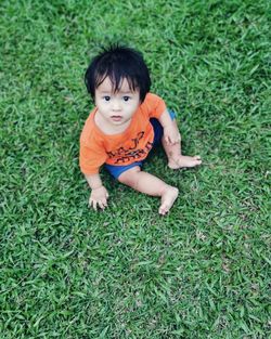Portrait of cute baby girl on field